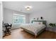 Bright bedroom features hardwood floors, a comfortable bed, and lots of natural light from a large window at 154 Boots Branch Rd, Summerville, SC 29485