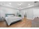 Bright bedroom with tray ceiling, hardwood floors, and multiple windows offering plenty of sunlight at 154 Boots Branch Rd, Summerville, SC 29485
