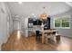 Well-lit dining area with wood flooring, modern light fixture and adjacent kitchen at 154 Boots Branch Rd, Summerville, SC 29485