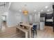 Dining area with a long wooden table, bench seating, and open view to the kitchen at 154 Boots Branch Rd, Summerville, SC 29485