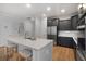 Bright kitchen features a large island, stainless steel appliances, and stylish dark gray cabinetry at 154 Boots Branch Rd, Summerville, SC 29485