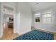 Bonus room features wood floors, a blue rug, and natural light from large windows with views of the outdoors at 154 Boots Branch Rd, Summerville, SC 29485