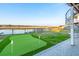 Backyard features a putting green with water views, stone patio, and access to the dock at 1614 Teal Marsh Rd, Charleston, SC 29412