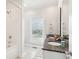 Bathroom with a granite countertop, double sinks, a window, and tiled shower-tub combo at 1614 Teal Marsh Rd, Charleston, SC 29412
