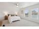 Bright bedroom with windows, ceiling fan, and comfortable bed with throw pillows at 1614 Teal Marsh Rd, Charleston, SC 29412