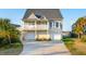 Charming two-story coastal home with dual garages and inviting outdoor space, blending comfort and style at 1614 Teal Marsh Rd, Charleston, SC 29412