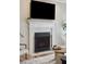 Close-up of a modern fireplace with a white mantel and black screen at 1614 Teal Marsh Rd, Charleston, SC 29412