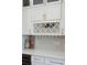 Elegant kitchen includes white cabinets, wine storage, glass racks, and modern countertops at 1614 Teal Marsh Rd, Charleston, SC 29412