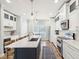 Bright kitchen features a large island, stainless appliances, white cabinets, and a wood floor at 1614 Teal Marsh Rd, Charleston, SC 29412