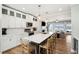 Open kitchen features a large island, stainless appliances, white cabinets, and access to living room at 1614 Teal Marsh Rd, Charleston, SC 29412