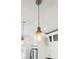 Pendant lighting over kitchen with textured clear glass shades, chain and aged bronze accents at 1614 Teal Marsh Rd, Charleston, SC 29412
