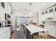 Open kitchen features a large island with seating, stainless appliances, and open access to the living room at 1614 Teal Marsh Rd, Charleston, SC 29412