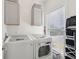 Well-lit laundry room with modern washer and dryer units, cabinetry, and window at 1614 Teal Marsh Rd, Charleston, SC 29412