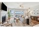 Open living area with fireplace, large windows offering scenic views, and stylish furniture at 1614 Teal Marsh Rd, Charleston, SC 29412