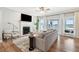 Cozy living room with a fireplace, large windows, and comfortable seating at 1614 Teal Marsh Rd, Charleston, SC 29412