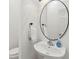 Clean powder room featuring a pedestal sink, round mirror, and fresh towels at 1614 Teal Marsh Rd, Charleston, SC 29412