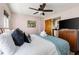 Cozy bedroom with soft bedding, a wooden cabinet with a television, and natural light at 162 Spring St # A, Charleston, SC 29403