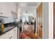 Galley kitchen with stainless appliances, white cabinetry, and access to dining area at 162 Spring St # A, Charleston, SC 29403