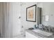 Bright bathroom with a shower, tub, and granite countertop vanity at 162 Spring St # D, Charleston, SC 29403