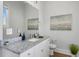 Bright bathroom featuring granite countertop, white cabinets, and a decorative painting at 162 Spring St # D, Charleston, SC 29403