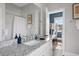 Bathroom featuring granite countertop, white cabinets, and view to bedroom with bunk beds at 162 Spring St # D, Charleston, SC 29403