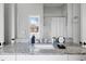 Bathroom with granite countertop, white cabinets, mirror reflecting shower and adjacent room at 162 Spring St # D, Charleston, SC 29403