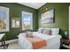 Comfortable bedroom with lots of natural light and stylish green walls at 162 Spring St # D, Charleston, SC 29403
