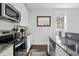 Modern kitchen with granite countertops and stainless steel appliances at 162 Spring St # D, Charleston, SC 29403