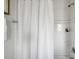 Shower with white subway tiles, white shower curtain, and shower niche at 162 Spring St # D, Charleston, SC 29403