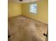 A yellow bedroom with tile floors and one window at 1633 Southwick Dr, Johns Island, SC 29455