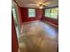 A red bedroom with tile floors, natural light, and a ceiling fan at 1633 Southwick Dr, Johns Island, SC 29455