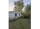 Exterior corner of a house with weathered siding, small windows and overgrown plants at 1633 Southwick Dr, Johns Island, SC 29455
