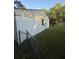 Side view of a house with a white exterior, a chain link fence, and green lawn at 1633 Southwick Dr, Johns Island, SC 29455