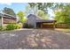 Backyard with a detached garage featuring a covered carport and gravel parking at 1637 Pinckney Park Dr, Charleston, SC 29407
