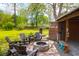 Backyard patio features a stone fire pit and cozy seating, perfect for outdoor enjoyment at 1637 Pinckney Park Dr, Charleston, SC 29407
