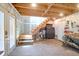 Unfinished basement space with exposed wooden beams, tool storage, and access to the backyard through a door at 1637 Pinckney Park Dr, Charleston, SC 29407