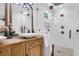 Bright bathroom features a double vanity, a large mirror, and a frameless shower at 1637 Pinckney Park Dr, Charleston, SC 29407