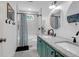 Bright bathroom featuring a double vanity, two mirrors, and a shower-tub combination at 1637 Pinckney Park Dr, Charleston, SC 29407