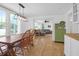 Bright dining room with hardwood floors and a view to the comfortable living room beyond at 1637 Pinckney Park Dr, Charleston, SC 29407