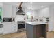 Modern kitchen featuring stainless steel appliances, white cabinets, and a central island at 1637 Pinckney Park Dr, Charleston, SC 29407