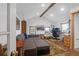Bright living room with a large sofa, hardwood floors, and a dedicated workspace near the window at 1637 Pinckney Park Dr, Charleston, SC 29407
