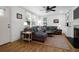 Comfortable living room featuring a large sectional couch, ceiling fan, hardwood floors, and bright windows at 1637 Pinckney Park Dr, Charleston, SC 29407