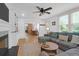 Bright, open living room with a decorative fireplace, hardwood floors, and plenty of natural light at 1637 Pinckney Park Dr, Charleston, SC 29407
