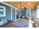 Cozy screened-in porch features movie projector, comfortable seating, and backyard access at 1637 Pinckney Park Dr, Charleston, SC 29407