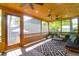 Relaxing screened-in porch with comfortable seating, ceiling fan, and view of backyard at 1637 Pinckney Park Dr, Charleston, SC 29407