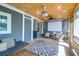 Cozy screened-in porch features movie projector, comfortable seating, and backyard access at 1637 Pinckney Park Dr, Charleston, SC 29407