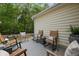 Outdoor seating on back porch with wood-look decking and comfortable chairs at 1726 Waterbrook Dr, Charleston, SC 29414