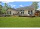 Expansive backyard featuring a well-maintained lawn and a charming deck with seating at 1726 Waterbrook Dr, Charleston, SC 29414