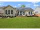 Expansive backyard featuring a well-maintained lawn and a charming deck with seating at 1726 Waterbrook Dr, Charleston, SC 29414