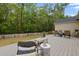 Landscaped backyard features a patio with comfortable seating, set against a backdrop of lush trees at 1726 Waterbrook Dr, Charleston, SC 29414